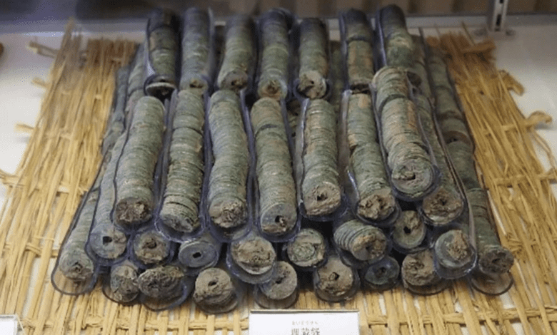 Here we see some of the coin bundles.  If you look closely, you can see square holes in the center of the coins where a string may have held them together.